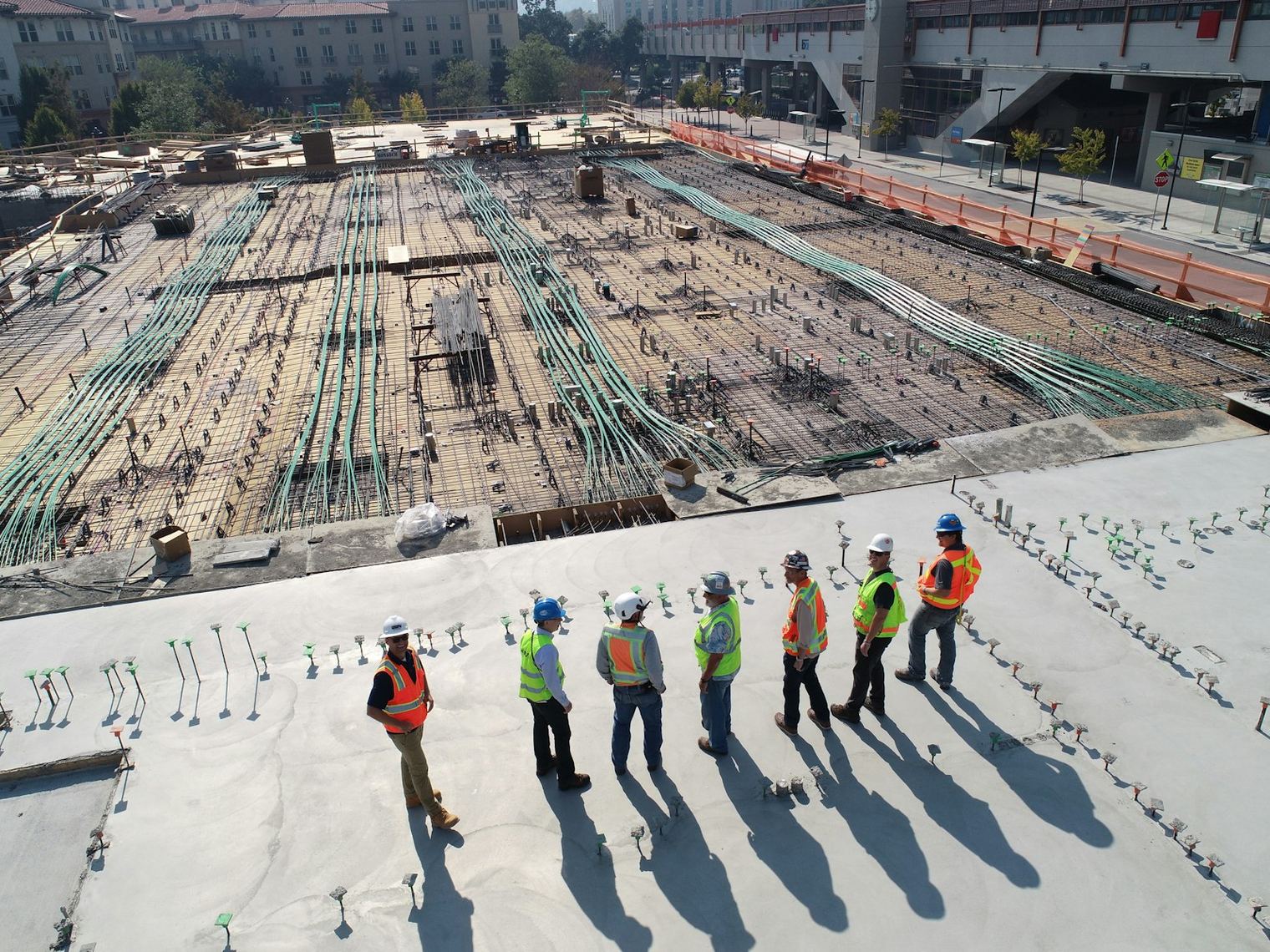 A construction team in hi-vis gathered on site